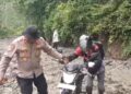 Sigap dan Peduli, Kapolsek Syiah Utama Turun Langsung Bantu Warga yang Terjebak Di Jalan yang Tertimbun Longsor.